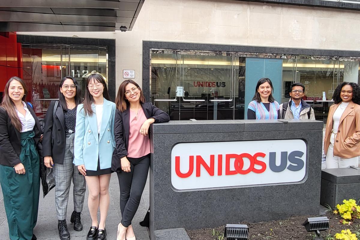 Group in front of UNIDOS sign. 