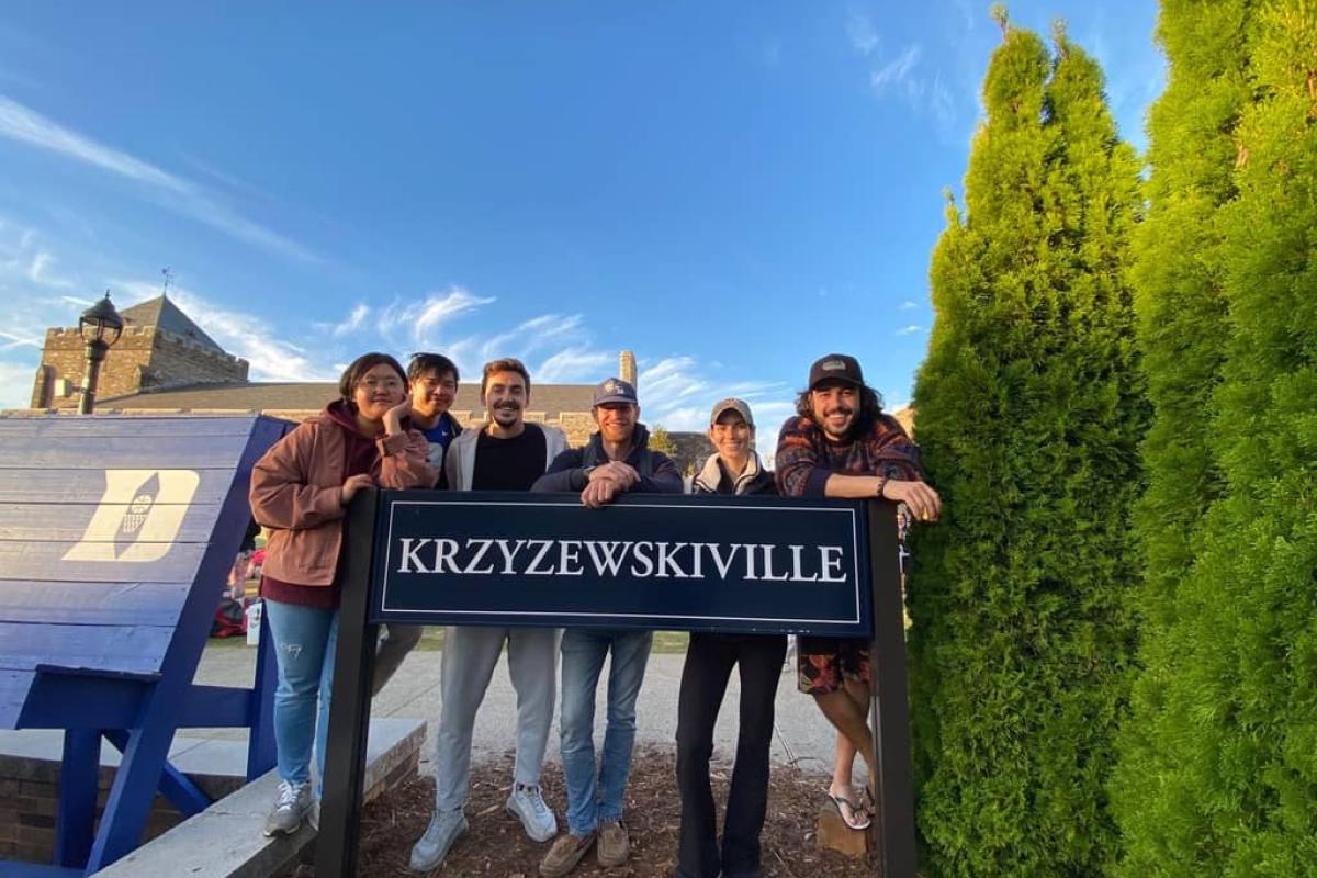 6 students posing outside near KVille sign