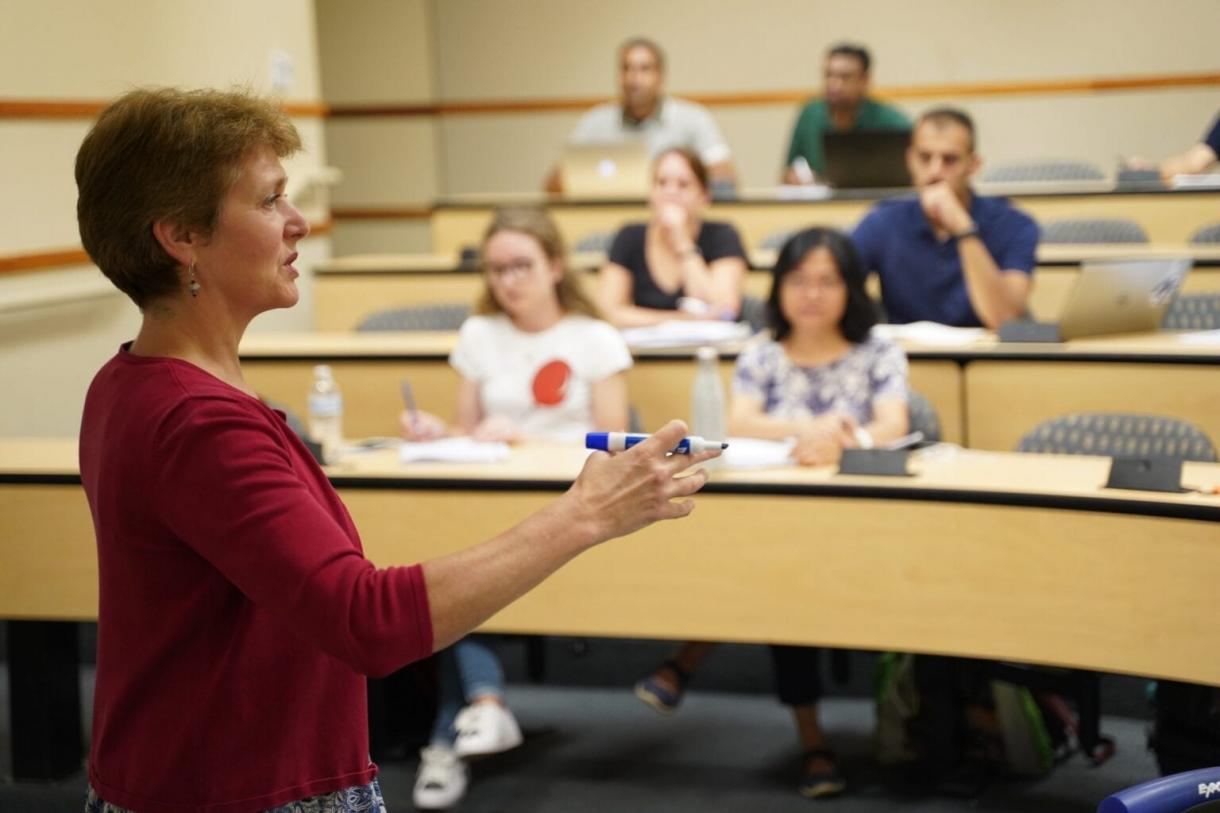 Corrine Krupp in front of a classroom of student at Sanford School of Public Policy