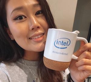 Woman smiling and holding coffee mug