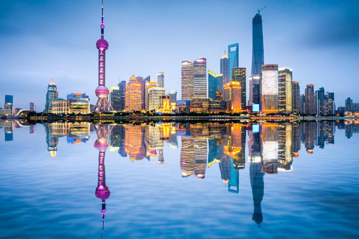 beautiful high tech skyline of Shanghai reflecting in water in foreground