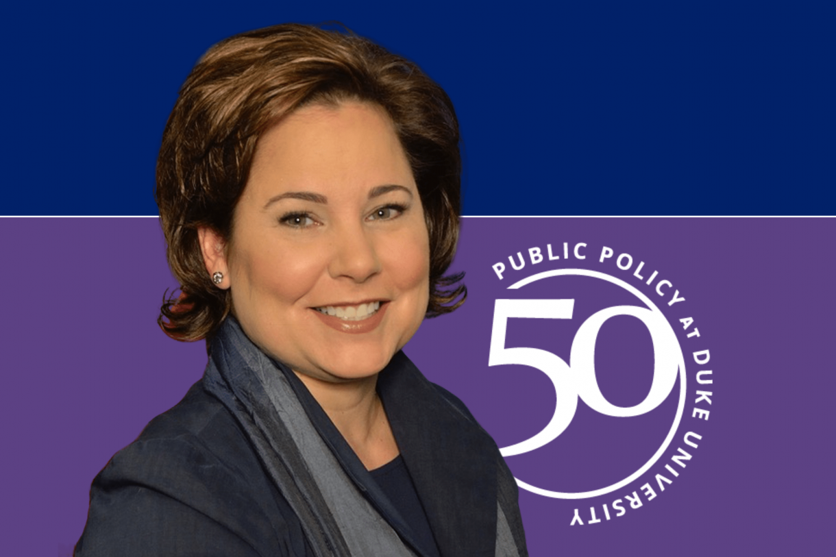 smiling Woman; 50 years of public policy at Duke logo