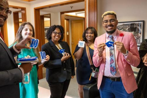 Students pose with graduation cookies
