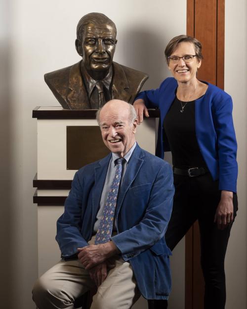 Founding Director and Professor Joel Fleishman with Dean Judith Kelley in the Sanford Building, alongside a statue of Terry Sanford