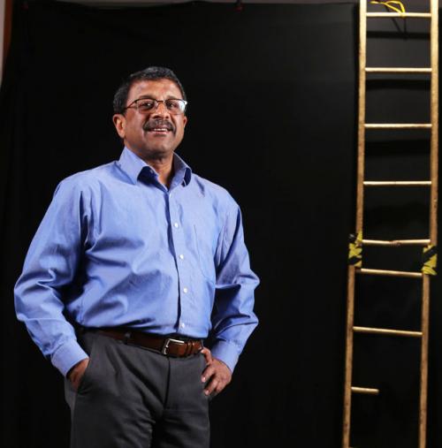 Anirudh Krishna standing by a ladder