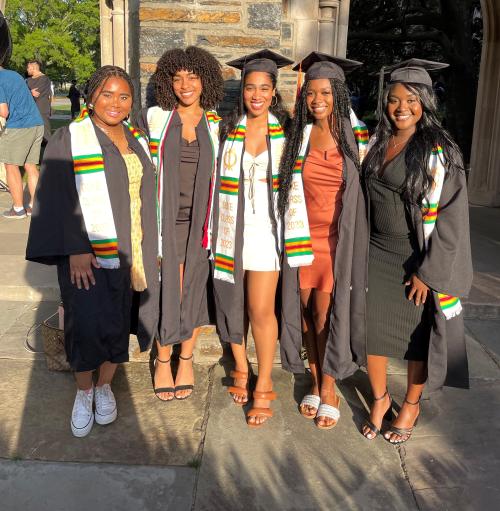 Gabby in middle posing in front of Duke Chapel with other graduates.