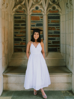 Woman, pretty dress and graduation cap