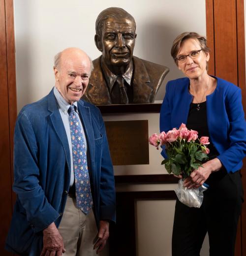Judith Kelley and Joel Fleishman pose with a bust of the founder of the Sanford School, Terry Sanford