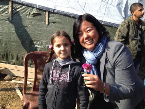 Melissa Lan Standing with Syrian refugee girl