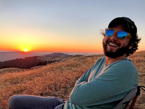 Nathan Ranney, laughing at sunset in the mountains