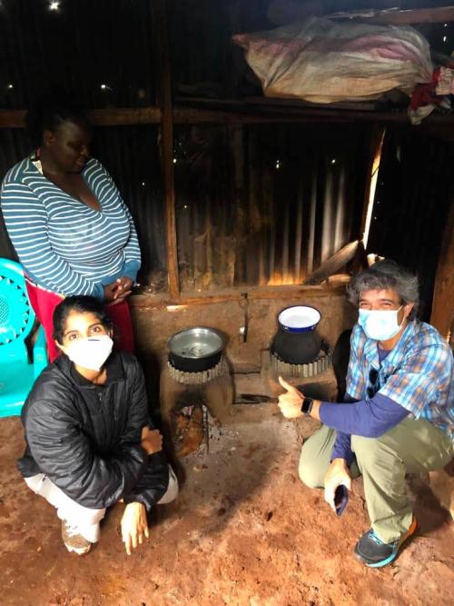 Researchers pose near cookstoves