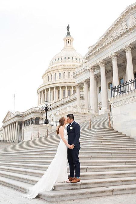 bride and groom kissing on steps of us capitol