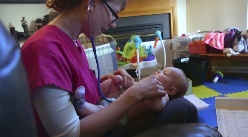 nurse taking babys heartbeat